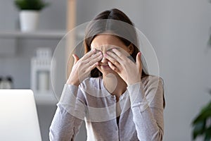 Tired teen girl rubbing dry irritable eyes feel eyestrain tension