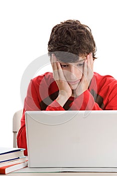 Tired teenage boy using laptop