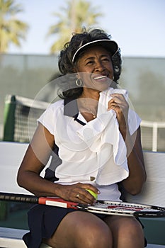 Tired Tennis Player Wiping Sweat With Napkin