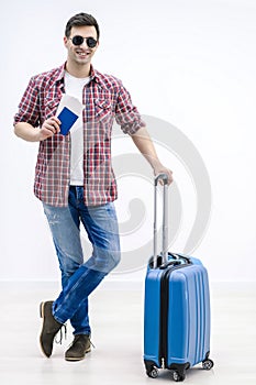 Tired tourist in anticipation of landing on aircraft waiting with baggage in airport terminal.