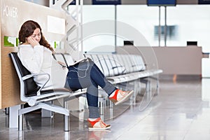 Tired transit passenger sleeping in airport