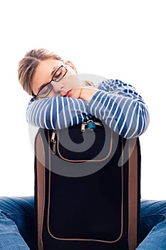 Tired traveller tourist woman sleeping on luggage