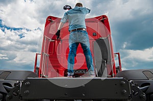 Tired Trucker on Back of His Truck Tractor Fifth Wheel