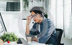 Tired and unhappy customer service operator man with headsets working at call centre, Call center agent with problem on