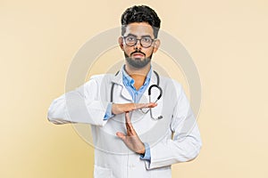 Tired upset doctor man showing pause gesture, limit or stop sign, time out, take a break relax, rest