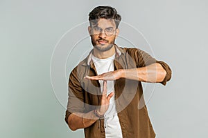 Tired upset Indian man showing pause gesture, limit or stop sign, time out, take a break relax, rest