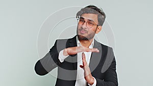 Tired upset Indian man showing pause gesture, limit or stop sign, time out, take a break relax, rest