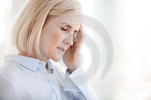 Tired upset mature old businesswoman suffering from strong chron