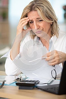tired upset mature old businesswoman suffering from strong headache