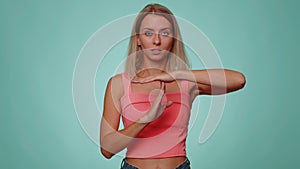 Tired upset woman showing time out gesture, limit stop break sign no pressure I need more time