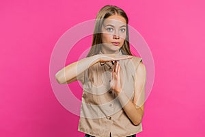 Tired upset young woman showing time out gesture, limit or stop sign, bored of work, take a break