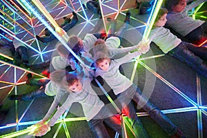 Tired of wandering girl lies on floor in mirror maze