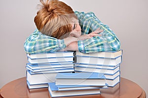 Tired woman and books