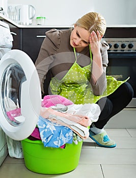 Tired woman doing laundry