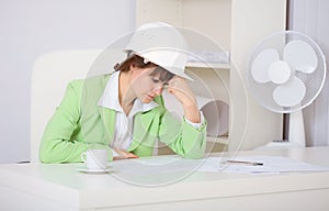 Tired woman engineer in workplace