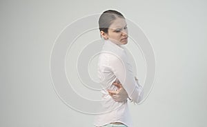 Tired woman feeling neck pain, massaging tense muscles. back pain and lower back view