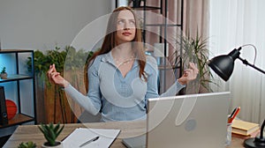 Tired woman freelancer suffering from headache migaine , closing eyes meditating at home office