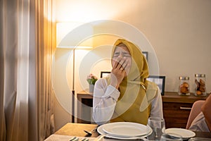 tired woman having break fast or sahur in the morning