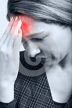 Tired woman with headache or migraine photo