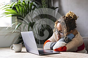 Tired woman at home asleep in front of a computer. Overwork laptop use concept. Female people sleeping on the table while use