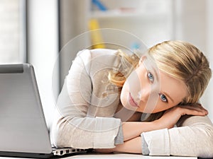 Tired woman with laptop computer photo