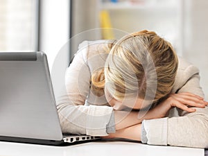 Tired woman with laptop computer photo