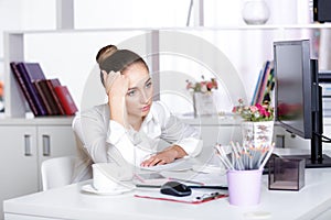 Tired woman manager in the office