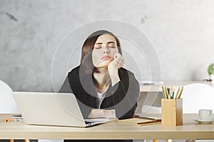 Tired woman at office desk