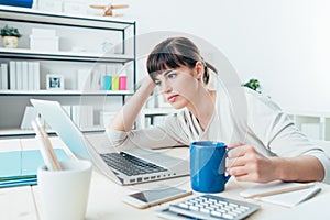 Tired woman at office desk
