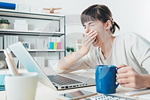 Tired woman at office desk photo