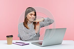 Tired woman office worker showing time out gesture looking at laptop screen, talking on video call, asking pause, break of online