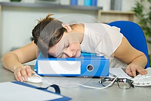 Tired woman sleeping in office photo