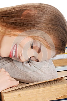 Tired woman slepping on books