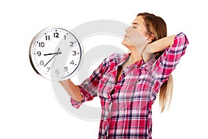 Tired woman stretches and holding a clock