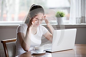 Tired woman suffering from headache having eyes strain