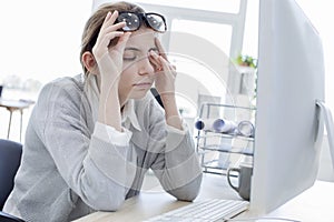 Tired woman touching her eyes
