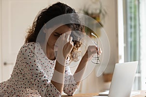 Tired woman work on computer suffer from headache