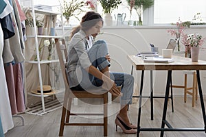 Tired woman worker massage feet suffer from uncomfortable shoes