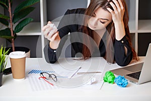 Tired woman working at the computer in the office