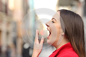 Tired woman yawning in the street
