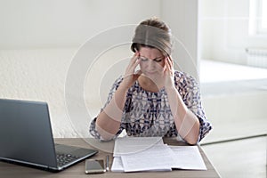 Tired of work woman holding her head