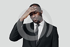 Tired young African man in formalwear