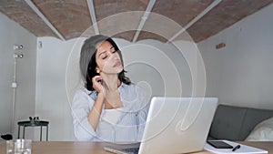 Tired young business woman taking a moment for relax while working with her laptop in the office.