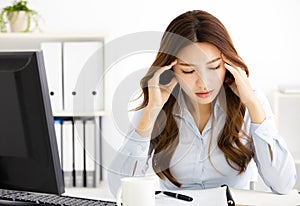 tired young business woman working in office