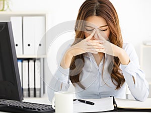 tired young business woman working in office photo