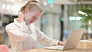 Tired Young Businesswoman with Laptop having Neck Pain