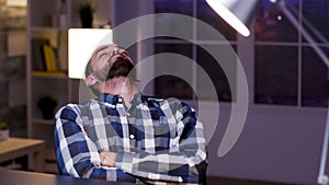 Tired young caucasian entrepreneur sleeping on chair