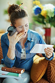 Tired young female with tablet PC and coffee cup study online