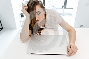 Tired, Young Girl Works at Home at the Computer in Quarantine.