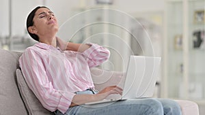 Tired Young Latin Woman with Laptop having Neck Pain at Home